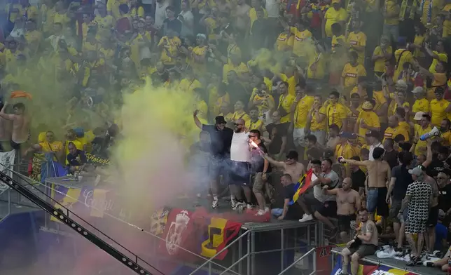 Romania fans cheer during a Group E match against Slovakia at the Euro 2024 soccer tournament in Frankfurt, Germany, Wednesday, June 26, 2024. (AP Photo/Darko Vojinovic)