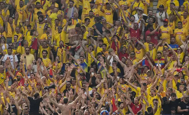 Romanian fans cheer during a Group E match against Slovakia at the Euro 2024 soccer tournament in Frankfurt, Germany, Wednesday, June 26, 2024. (AP Photo/Themba Hadebe)