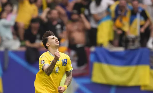 Ukraine's Mykola Shaparenko celebrates after scoring his side's opening goal during a Group E match between Slovakia and Ukraine at the Euro 2024 soccer tournament in Duesseldorf, Germany, Friday, June 21, 2024. (Fabio Ferrari/LaPresse via AP)