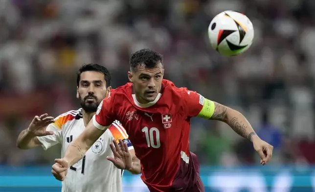 Switzerland's Granit Xhaka, right, fight for the ball with Germany's Ilkay Gundogan during a Group A match between Switzerland and Germany at the Euro 2024 soccer tournament in Frankfurt, Germany, Sunday, June 23, 2024. (AP Photo/Martin Meissner)