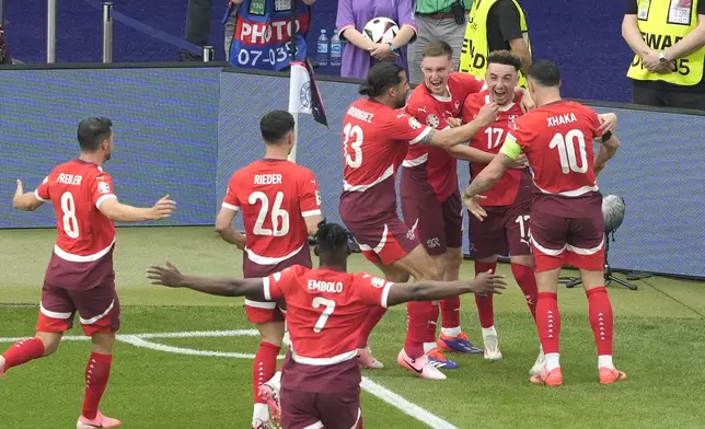 Switzerland's Ruben Vargas, center right, celebrates with teammates after scoring his side's second goal during a round of sixteen match between Switzerland and Italy at the Euro 2024 soccer tournament in Berlin, Germany, Saturday, June 29, 2024.(AP Photo/Markus Schreiber)