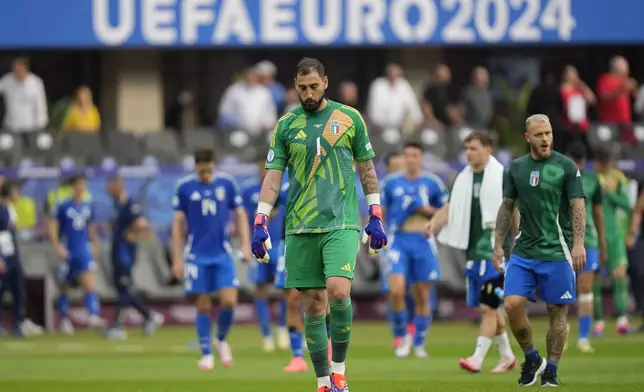 Italy's goalkeeper Gianluigi Donnarumma walks off at the end of a round of sixteen match between Switzerland and Italy at the Euro 2024 soccer tournament in Berlin, Germany, Saturday, June 29, 2024. Switzerland won the game 2-0. (AP Photo/Ariel Schalit)