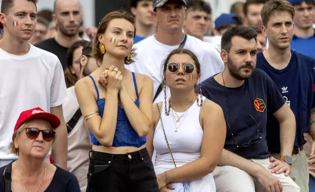 People watch a round of sixteen match between Switzerland and Italy at the Euro 2024 soccer tournament in Germany during a public viewing in Milan, Italy, Saturday, June 29, 2024. (Stefano Porta/LaPresse via AP)