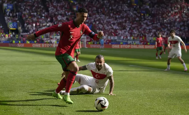 Portugal's Cristiano Ronaldo, left, controls the ball as Turkey's Abdulkerim Bardakci falls down during a Group F match between Turkey and Portugal at the Euro 2024 soccer tournament in Dortmund, Germany, Saturday, June 22, 2024. (AP Photo/Themba Hadebe)