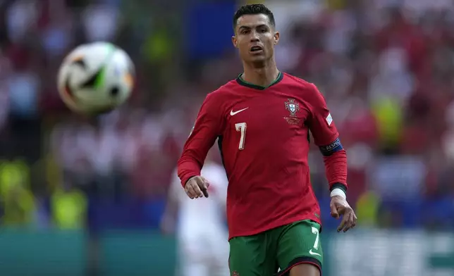 Portugal's Cristiano Ronaldo looks the ball during a Group F match between Turkey and Portugal at the Euro 2024 soccer tournament in Dortmund, Germany, Saturday, June 22, 2024. (AP Photo/Themba Hadebe)