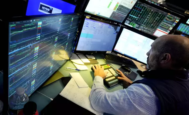 FILE - Specialist James Denaro works at his post on the floor of the New York Stock Exchange on June 12, 2024. Global shares were mixed on Friday, June 14, 2024, after Wall Street touched fresh records, with benchmarks pushed higher by the frenzy over artificial intelligence technology. (AP Photo/Richard Drew, File)