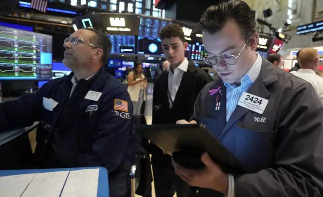 FILE - Trader William Lovesick, right works on the floor of the New York Stock Exchange, June 12, 2024. Shares have opened mixed in Europe on Monday, June 17, 2024, as markets recovered from shocks of recent elections across the region. (AP Photo/Richard Drew, File)