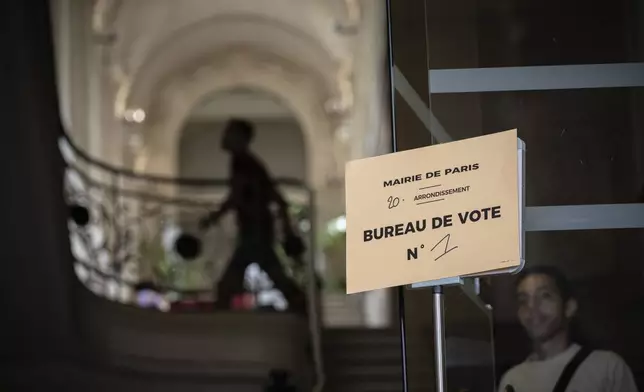 Voters at a polling station in the first round of the French parliamentary elections in Paris, Sunday, June 30, 2024. Voters across mainland France are casting ballots in the first round of an exceptional parliamentary election. (AP Photo/Aurelien Morissard)