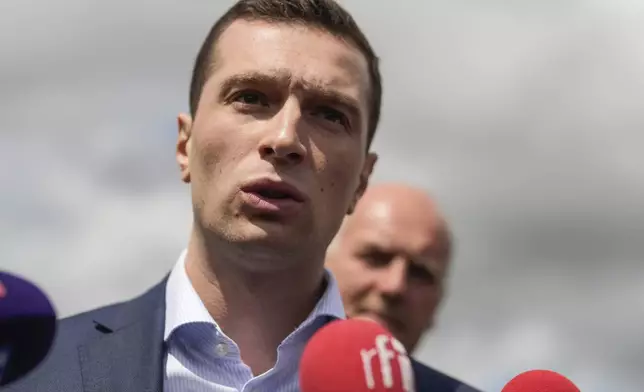Jordan Bardella far-right National Rally leader for the upcoming election speaks to the media as he visits a farm in Chuelles, 137 kms (85 miles) south of Paris, Friday, June 14, 2024. The election is to take place in two rounds on June 30 and July 7. (AP Photo/Thibault Camus)