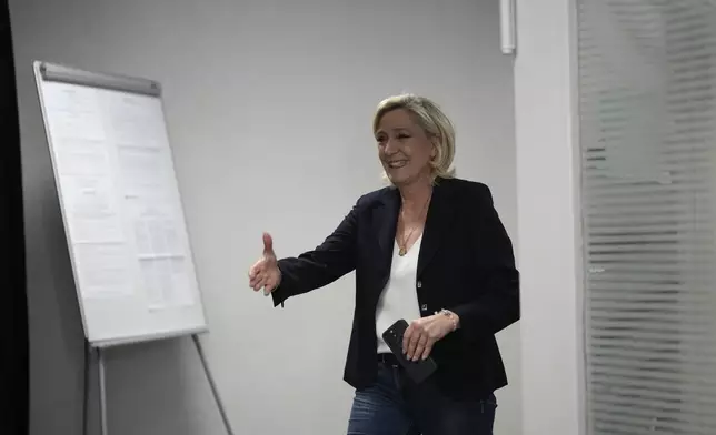 French far right leader Marine Le Pen arrives to vote, Sunday, June 30, 2024 in Henin-Beaumont, northern France. France is holding the first round of an early parliamentary election that could bring the country's first far-right government since Nazi occupation during World War II. The second round is on July 7, and the outcome of the vote remains highly uncertain. (AP Photo/Thibault Camus)
