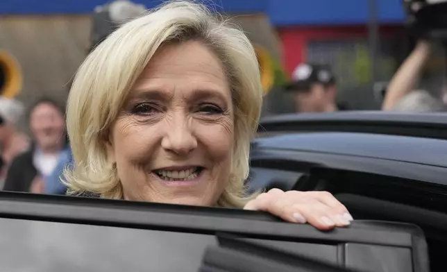 French far right leader Marine Le Pen leaves after voting in the first round of the parliamentary election, Sunday, June 30, 2024 in Henin-Beaumont, northern France. France is holding the first round of an early parliamentary election that could bring the country's first far-right government since Nazi occupation during World War II. The second round is on July 7, and the outcome of the vote remains highly uncertain. (AP Photo/Thibault Camus)