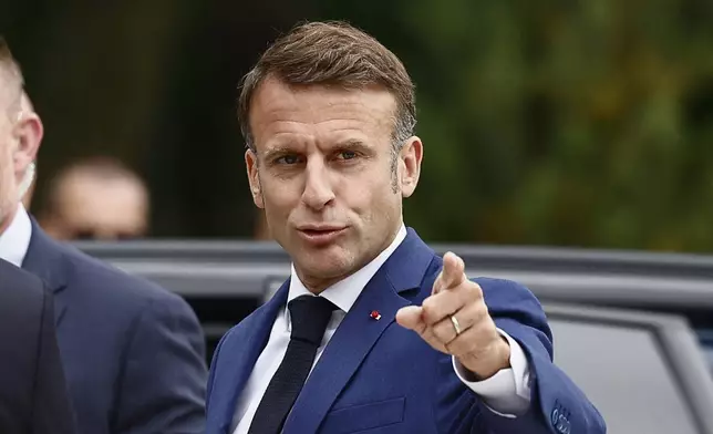 French President Emmanuel Macron gestures as he arrives at a polling station to to vote in the first round of the early French parliamentary elections, in Le Touquet-Paris-Plage, northern France, Sunday, June 30, 2024. France is holding the first round of an early parliamentary election that could bring the country's first far-right government since Nazi occupation during World War II. The second round is on July 7, and the outcome of the vote remains highly uncertain (Yara Nardi, Pool via AP)