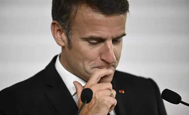 File - French President Emmanuel Macron reacts as he delivers his speech during the opening session of the the African Vaccine Manufacturing Accelerator conference, Thursday, June 20, 2024 in Paris. Emmanuel Macron once appeared as a bold, young leader offering to revive France through radical pro-business, pro-European policies so that voters have "no reason anymore" to vote for the extremes. Seven years after he was first elected, his call for snap elections weakens him at home and abroad, while it appears to propel the far right on the verge of power. (Dylan Martinez/Pool via AP, File)