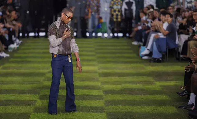 Creative director Pharrell Williams accepts applause following the Louis Vuitton Spring Summer 2025 collection, that was presented in Paris, Tuesday, June 18, 2024. (Photo by Vianney Le Caer/Invision/AP)