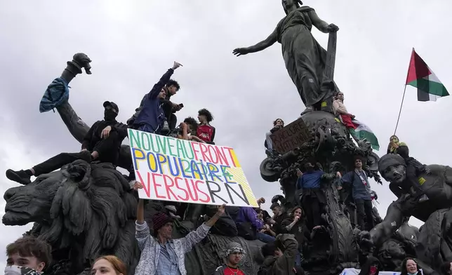 Protesters hold an anti-far right banner during a rally in Paris, Saturday, June 15, 2024. Anti-racism groups joined French unions and a brand-new left-wing coalition in protests in Paris and across France on Saturday against the surging nationalist far right as frenzied campaigning is underway ahead of snap parliamentary elections. (AP Photo/Michel Euler)