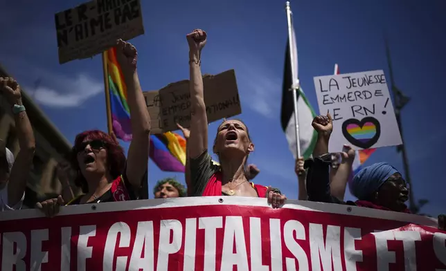 Protesters sing chants during a demonstration in Marseille, southern France, Saturday, June 15, 2024. Anti-racism groups joined French unions and a brand-new left-wing coalition in protests in Paris and across France on Saturday against the surging nationalist far right as frenzied campaigning is underway ahead of snap parliamentary elections. (AP Photo/Daniel Cole)