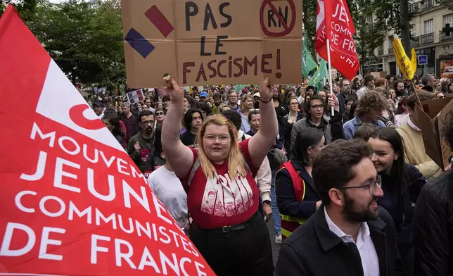 A protester holds an anti-far right banner during a rally in Paris, Saturday, June 15, 2024. Anti-racism groups joined French unions and a brand-new left-wing coalition in protests in Paris and across France on Saturday against the surging nationalist far right as frenzied campaigning is underway ahead of snap parliamentary elections. (AP Photo/Michel Euler)