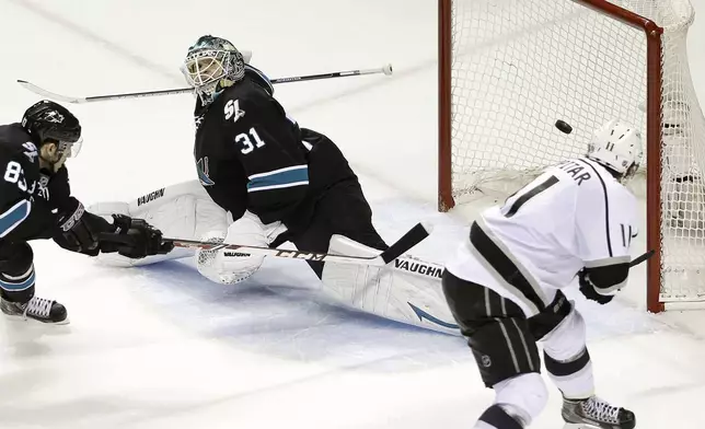 FILE - Los Angeles Kings center Anze Kopitar, right, scores a goal past San Jose Sharks goalie Antti Niemi (31) and left wing Matt Nieto (83) during the second period of Game 7 of an NHL hockey first-round playoff series in San Jose, Calif., April 30, 2014. The Kings trailed 3-0 in the series, but came back to win. (AP Photo, File)