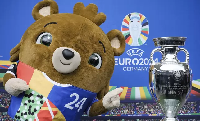 FILE - Tournament mascot 'Albaert' poses for the media during the presentation of the European soccer championship 'EURO 2024' trophy at the Olympic Stadium in Berlin, Germany, Wednesday, April 24, 2024. The Euros kick off in Munich, Friday June 14, when host country Germany plays Scotland at Bayern Munich's Allianz Arena. The tournament begins with six groups of four teams. (AP Photo/Markus Schreiber, File)