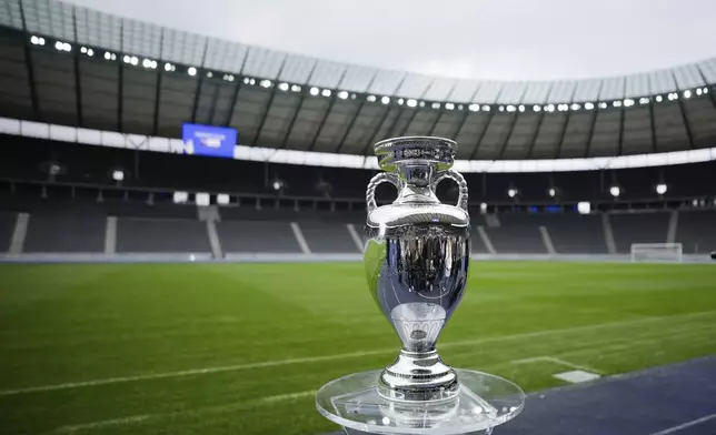 FILE - The trophy is on display during the presentation of the European soccer championship 'EURO 2024' trophy at the Olympic Stadium in Berlin, Germany, Wednesday, April 24, 2024. The Euros kick off in Munich, Friday June 14, when host country Germany plays Scotland at Bayern Munich's Allianz Arena. The tournament begins with six groups of four teams. (AP Photo/Markus Schreiber, File)