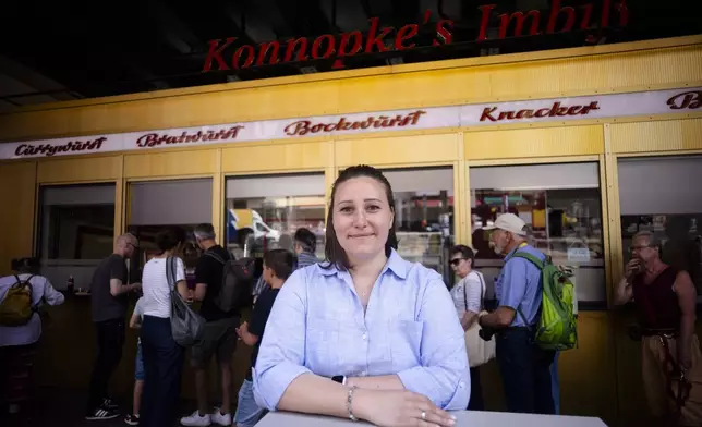 Linda Konnopke, the great-granddaughter of Max and CharlotteKonnopke, the founder of Konnopke's Imbiss, a fast food restaurant under the tracks at Eberswalder Straße subway station, poses for a photo, in Berlin, Germany, Friday, May 24, 2024. The currywurst, Germany's sausage with curry sauce, promises to be among the most tantalizing gourmet treats on offer at the European Championship this summer. The currywurst is considered a fast-food delicacy in a country where the humble sausage enjoys great importance. (AP Photo/Markus Schreiber)