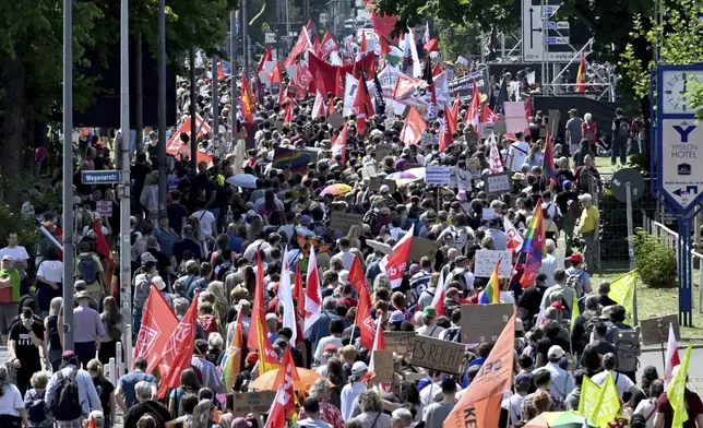 People gather to demonstrate against the AfD national party conference in Essen, Germany, Saturday June 29, 2024. The far-right Alternative for Germany party is holding a convention in the western city of Essen and large-scale protests against the party are taking place. (Henning Kaiser/dpa via AP)