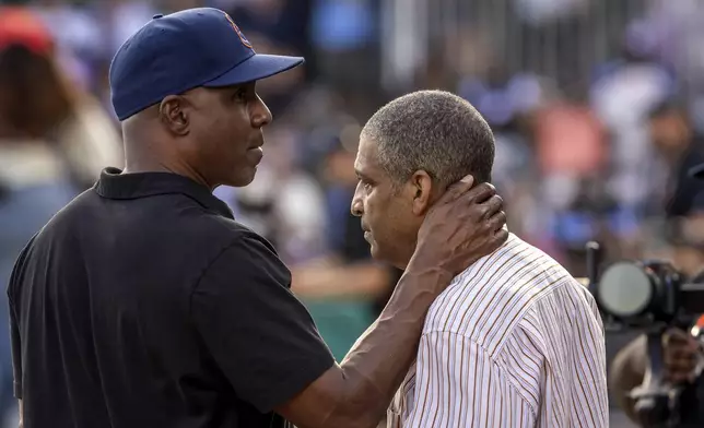 Barry Bonds, left, consoles Michael Mays, right, son of the late Willie Mays, before the baseball game between the San Francisco Giants and the St. Louis Cardinals at Rickwood Field in Birmingham, Ala., on Thursday, June 20, 2024. (Carlos Avila Gonzalez/San Francisco Chronicle via AP)