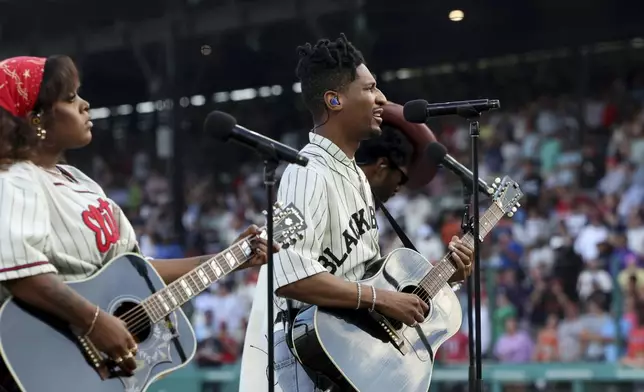 Musical artist Jon Batiste performs before the start of a baseball game between the St. Louis Cardinals and the San Francisco Giants at Rickwood Field, Thursday, June 20, 2024, in Birmingham, Ala. (AP Photo/Vasha Hunt)