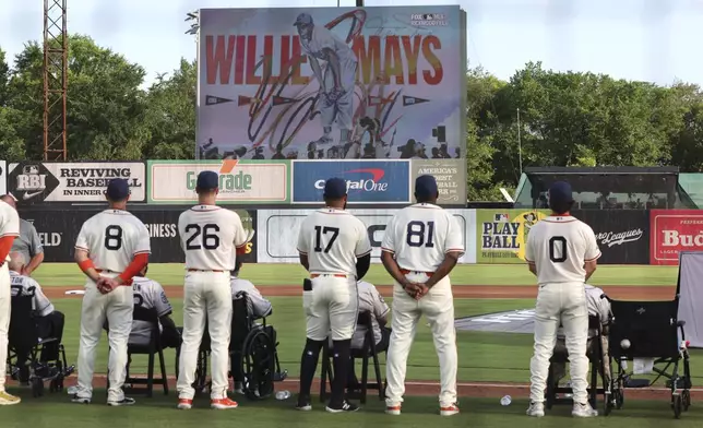 Players pause to honor Willie Mays before the start of a baseball game between the St. Louis Cardinals and the San Francisco Giants at Rickwood Field, Thursday, June 20, 2024, in Birmingham, Ala. (AP Photo/Vasha Hunt)