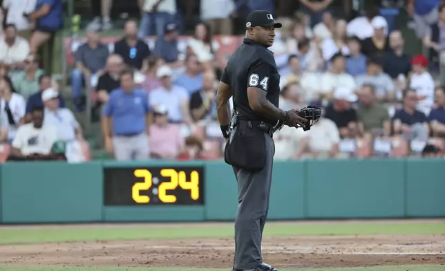 Home plate umpire Alan Porter pauses during the second inning of a baseball game between the St. Louis Cardinals and the San Francisco Giants at Rickwood Field, Thursday, June 20, 2024, in Birmingham, Ala. (AP Photo/Vasha Hunt)
