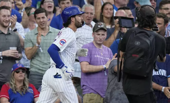 Chicago Cubs' Dansby Swanson runs to the dugout after hitting a two-run home run in the second inning of a baseball game against the San Francisco Giants in Chicago, Tuesday, June 18, 2024. (AP Photo/Nam Y. Huh)