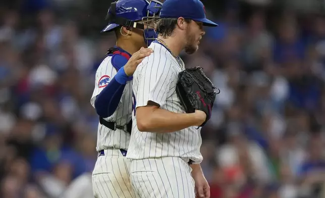 Chicago Cubs catcher Miguel Amaya, left, talks with starting pitcher Justin Steele during the fifth inning of a baseball game against the San Francisco Giants in Chicago, Tuesday, June 18, 2024. (AP Photo/Nam Y. Huh)