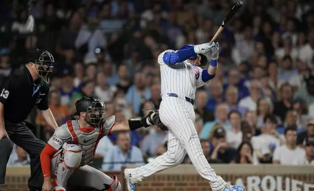 Chicago Cubs' Ian Happ hits an RBI single against the San Francisco Giants during the eighth inning of a baseball game in Chicago, Tuesday, June 18, 2024. (AP Photo/Nam Y. Huh)