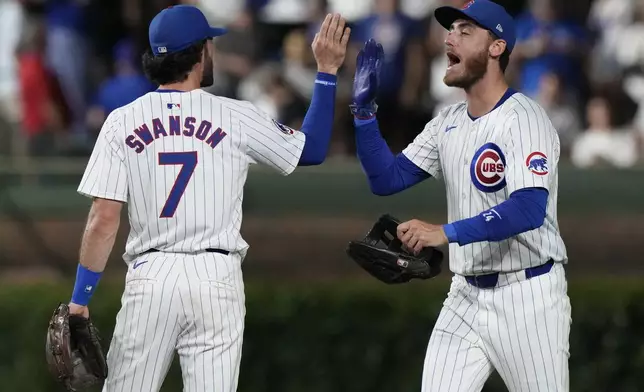 Chicago Cubs' Cody Bellinger, right, celebrates with Dansby Swanson after the Cubs defeated the San Francisco Giants in a baseball game in Chicago, Tuesday, June 18, 2024. (AP Photo/Nam Y. Huh)