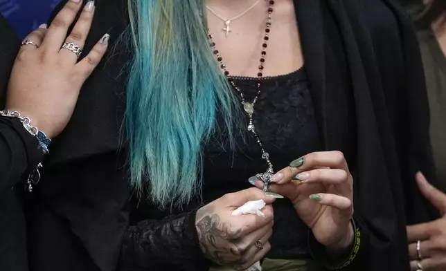 Alexis Nungaray, the mother of Jocelyn Nungaray, holds a rosary after speaking about her daughter during a news conference after Franklin Peña, one of the two men accused of killing the 12-year-old girl, appeared in court, Monday, June 24, 2024, in Houston. Peña was ordered held on $10 million bail as he and another man, Johan Jose Rangel-Martinez, are charged with capital murder over the girl's death. (Brett Coomer/Houston Chronicle via AP)