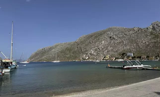 The small village of Pedi, where some reports indicate missing British doctor and TV presenter Michael Mosley was sighted, is seen on the southeastern Aegean Sea island of Symi, Greece, Friday, June, 7, 2024. Mosley went missing on Wednesday afternoon while on vacation on Symi, and authorities said a search and rescue operation that continued on Friday had found no trace of him. (AP Photo/Antonis Mystiloglou)