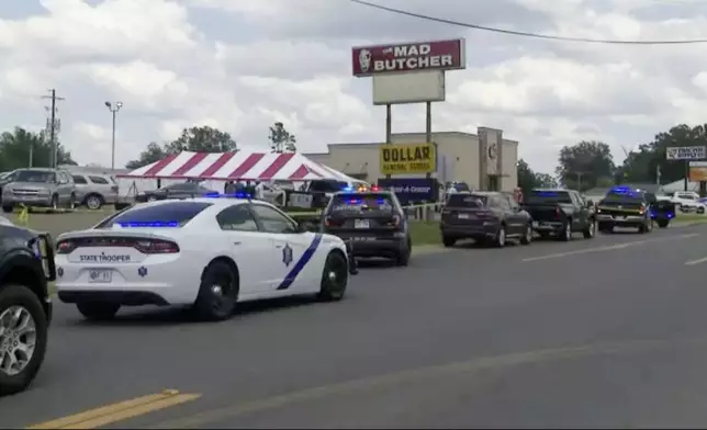 Police respond to the scene of a shooting on Friday, June 21, 2024 in Fordyce, Ark. Arkansas State Police say at least two people were killed and eight wounded in a shooting that occurred at a grocery store in south Arkansas. (KATV via AP)