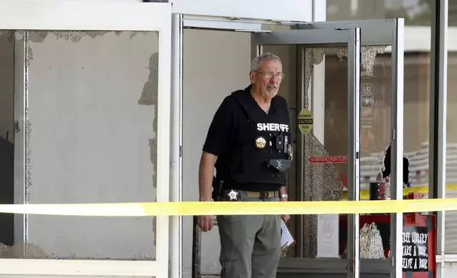 Law enforcement officers work the scene of a shooting at the Mad Butcher grocery store in Fordyce, Ark., Friday, June 21, 2024. (Colin Murphey/Arkansas Democrat-Gazette via AP)