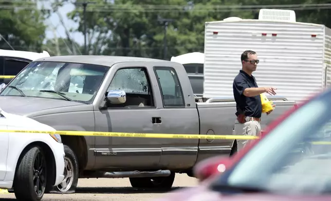 Law enforcement officers work the scene of a shooting at the Mad Butcher grocery store in Fordyce, Ark., Friday, June 21, 2024. (Colin Murphey/Arkansas Democrat-Gazette via AP)