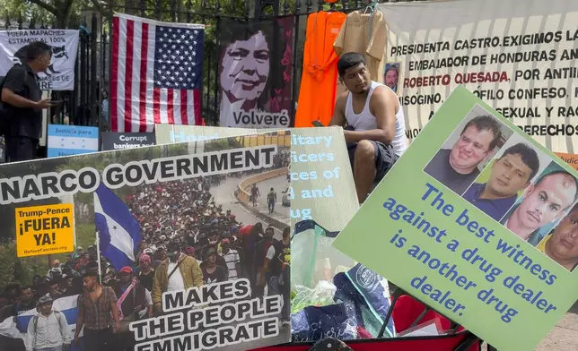 Protestors signs and images victims of Honduran drug traffickers outside Federal court, Wednesday, June 26, 2024, in New York. Former Honduran President Juan Orlando Hernandez is scheduled for sentencing after being convicted in New York of conspiring with drug traffickers, his military and police to enable tons of cocaine to reach the United States. (AP Photo/John Minchillo)