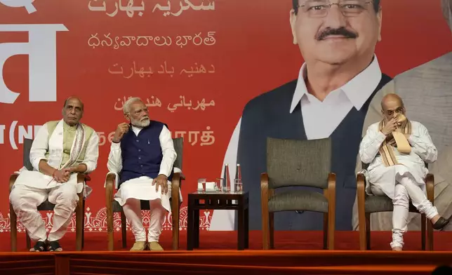 Prime Minister Narendra Modi shares the stage with Defense Minister Rajnath Singh, left, and Home Minister Amit Shah, right, before addressing supporters at the Bharatiya Janata Party (BJP) headquarters in New Delhi, India, Tuesday, June 4, 2024. (AP Photo/Manish Swarup)