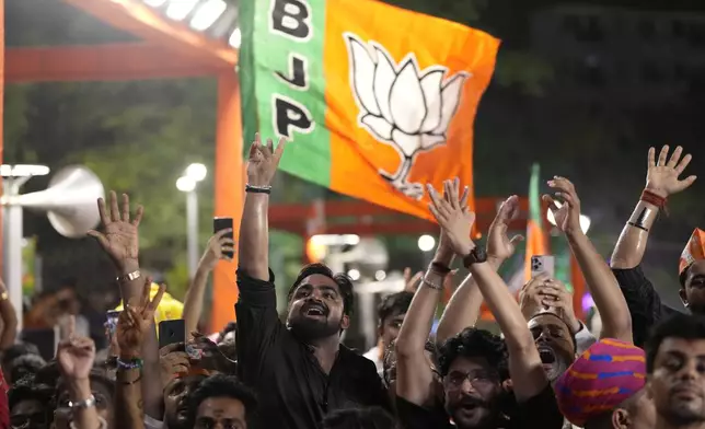 Bharatiya Janata Party (BJP) supporters shout slogans as they listen to Prime Minister Narendra Modi at the party headquarters in New Delhi, India, Tuesday, June 4, 2024. (AP Photo/Manish Swarup)