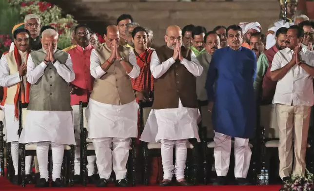 FILE - Indian Prime Minister Narendra Modi, left, greets along with his newly sworn in cabinet ministers at the swearing in ceremony at the forecourt of presidential palace in New Delhi, India, Thursday, May 30, 2019. Modi met with India's President Droupadi Murmu customarily and tendered his resignation along with his ministers ahead of the swearing-in ceremony likely to occur in the coming days. (AP Photo/Manish Swarup, File)