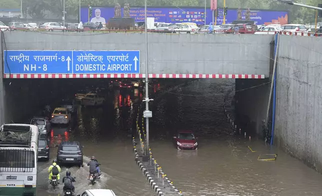A highway is clogged with water near the Indira Gandhi International Airport after heavy rains in New Delhi, India, Friday, June 28, 2024. (AP Photo)