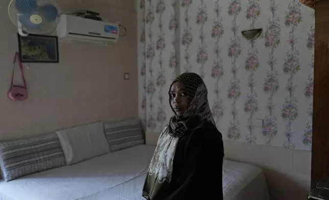 Sudanese woman Rawda Yousif, who has been in Indonesia for eight years, stands for a photograph in her room at Hotel Kolekta, turned into a shelter for refugees, in Batam, an island in northwestern Indonesia, Thursday, May 16, 2024. The former tourist hotel was converted in 2015 into a temporary shelter that today houses 228 refugees from conflict-torn nations including Afghanistan, Somalia, Sudan and elsewhere. (AP Photo/Dita Alangkara)