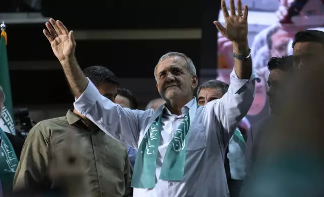 Reformist candidate for Iran's presidential election Masoud Pezeshkian waves to his supporters in his campaign meeting in Tehran, Iran, Sunday, June 23, 2024. (AP Photo/Vahid Salemi)