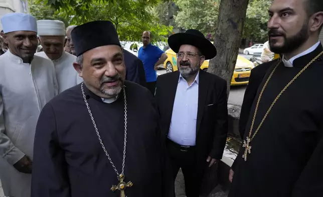 Religious leaders of the Iranian religious minorities, among them leader of the Iranian Jews Younes Hamami Lalehzar, center, arrive at a polling station to vote for the presidential election in Tehran, Iran, Friday, June 28, 2024. Iranians were voting Friday in a snap election to replace the late President Ebrahim Raisi, killed in a helicopter crash last month, as public apathy has become pervasive in the Islamic Republic after years of economic woes, mass protests and tensions in the Middle East. (AP Photo/Vahid Salemi)