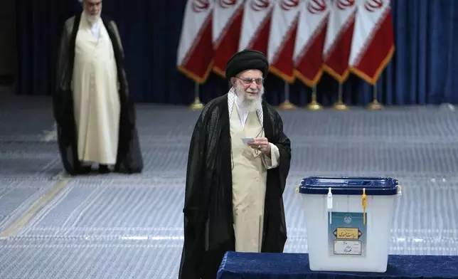 Iranian Supreme Leader Ayatollah Ali Khamenei walks towards the ballot box to cast his vote during the presidential election, in Tehran, Iran, Friday, June 28, 2024. Iranians were voting Friday in a snap election to replace the late President Ebrahim Raisi, killed in a helicopter crash last month, as public apathy has become pervasive in the Islamic Republic after years of economic woes, mass protests and tensions in the Middle East. (AP Photo/Vahid Salemi)