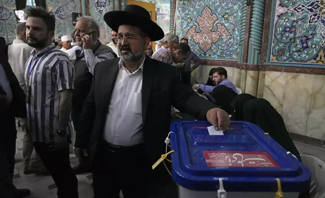 Religious leader of the Iranian Jews Younes Hamami Lalehzar casts his ballot during the presidential election at a polling station in Tehran, Iran, Friday, June 28, 2024. Iranians were voting Friday in a snap election to replace the late President Ebrahim Raisi, killed in a helicopter crash last month, as public apathy has become pervasive in the Islamic Republic after years of economic woes, mass protests and tensions in the Middle East. (AP Photo/Vahid Salemi)