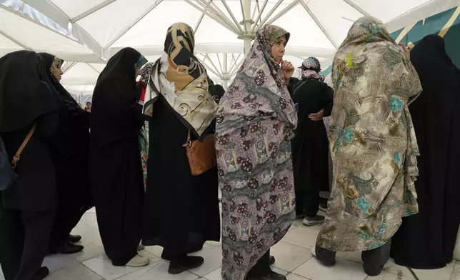 Iranian women line up to vote for the presidential election at a polling station at the shrine of Saint Saleh in northern Tehran, Iran, Friday, June 28, 2024. Iranians were voting Friday in a snap election to replace the late President Ebrahim Raisi, killed in a helicopter crash last month, as public apathy has become pervasive in the Islamic Republic after years of economic woes, mass protests and tensions in the Middle East. (AP Photo/Vahid Salemi)